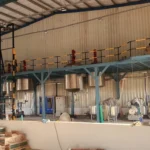Steel Tech Engineering close-up of stainless steel reactors with red agitator motors on mezzanine